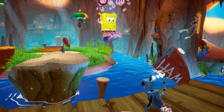 SpongeBob jumping over a lake towards a platform with a robot on it.