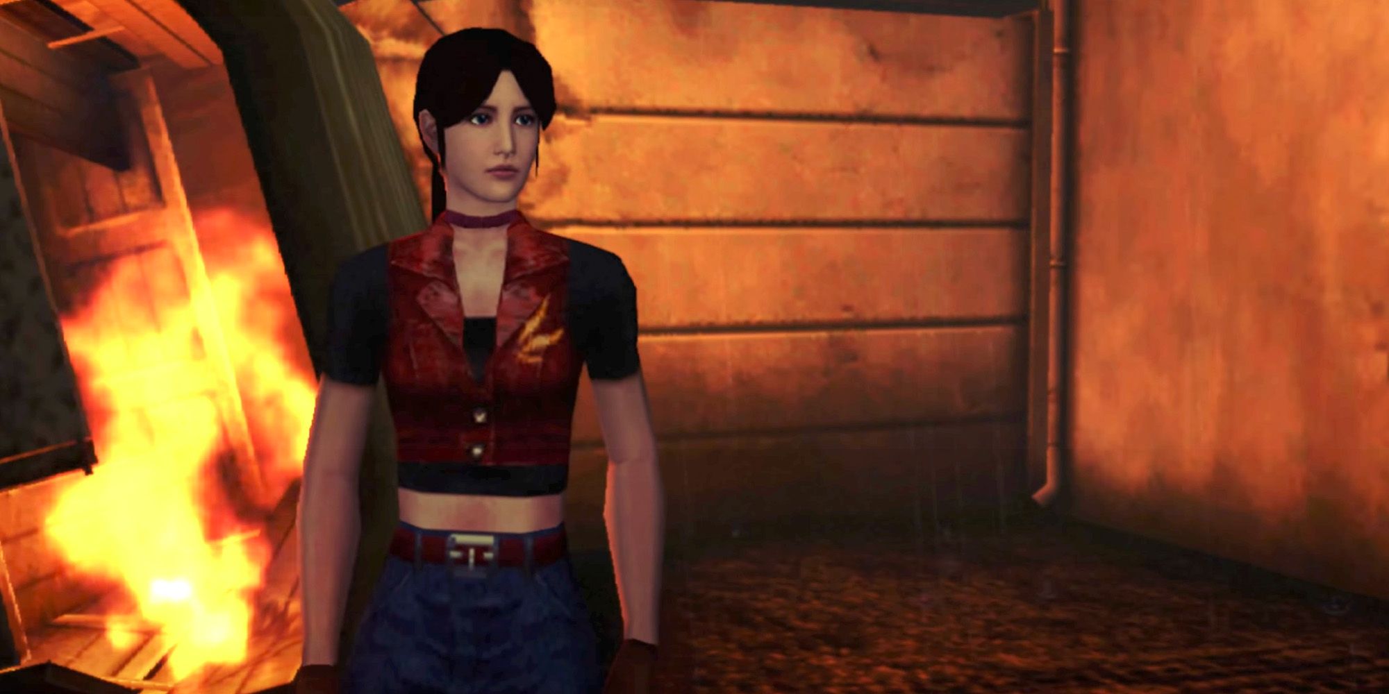Resident Evil Code Veronica – Claire Redfield steht vor einem brennenden Auto im Rockfort-Gefängnis