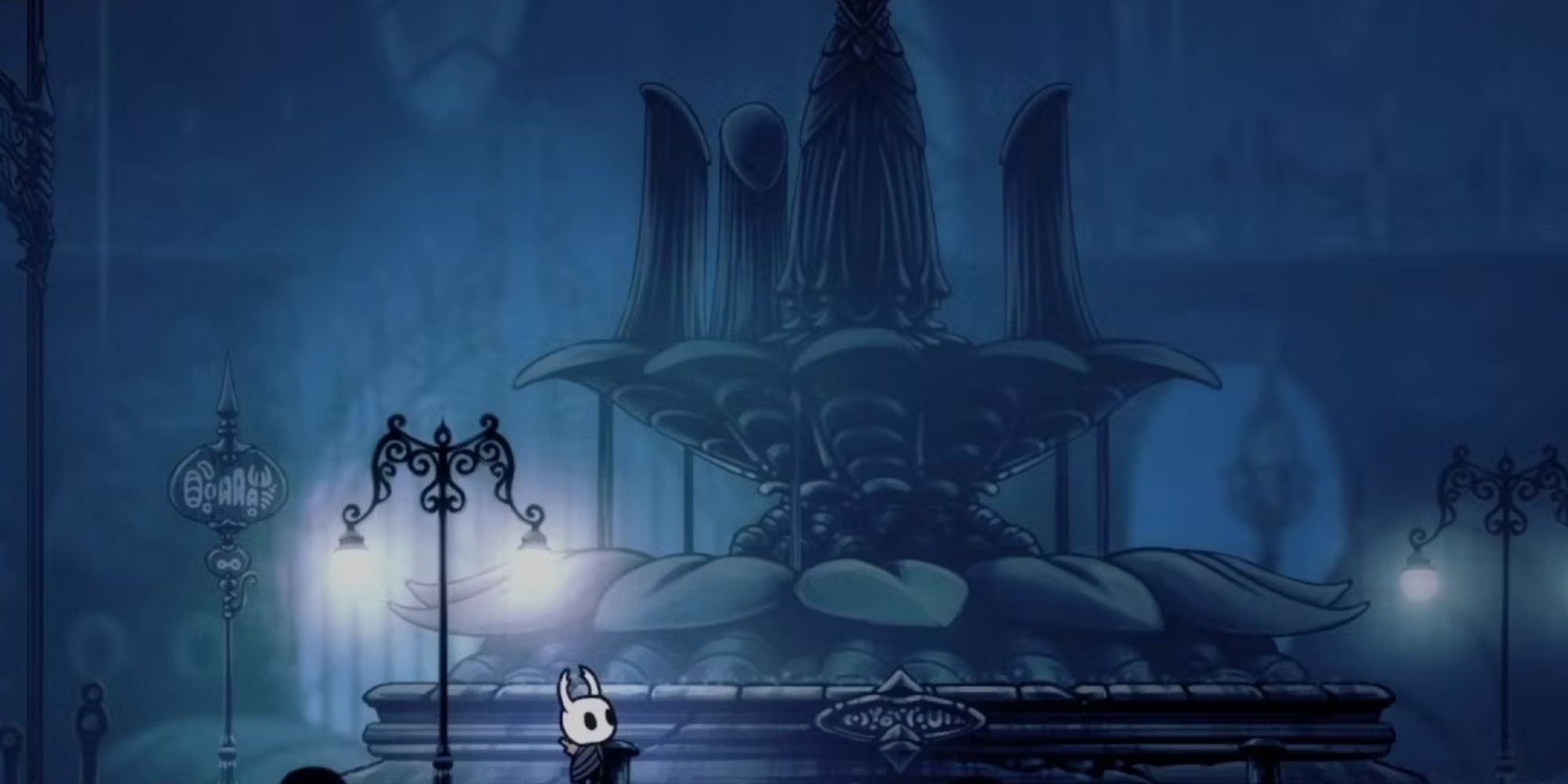 The Knight looking up at the memorial fountain in City of Tears in Hollow Knight