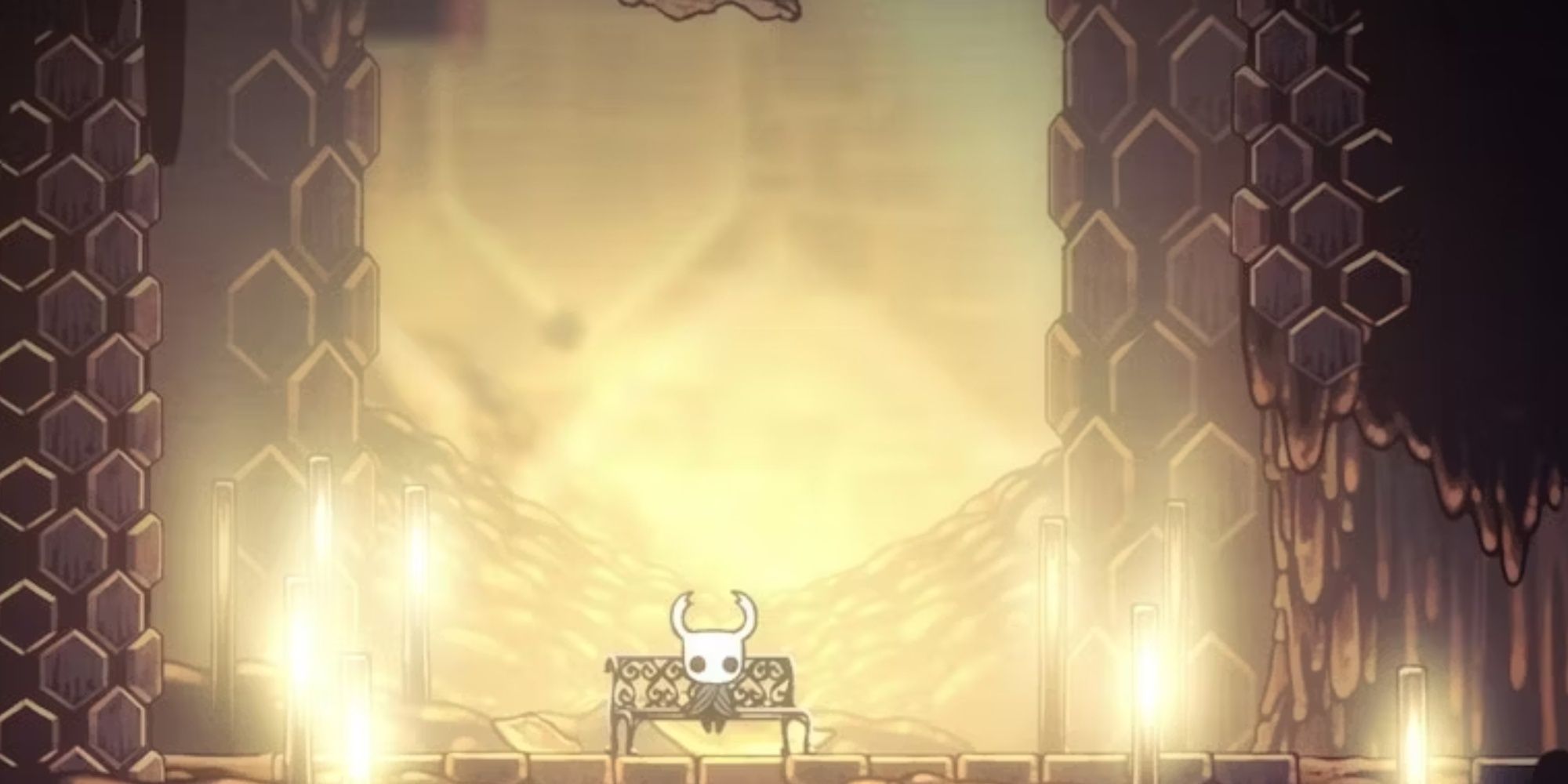 The Knight sat on a bench in the Hive in Hollow Knight
