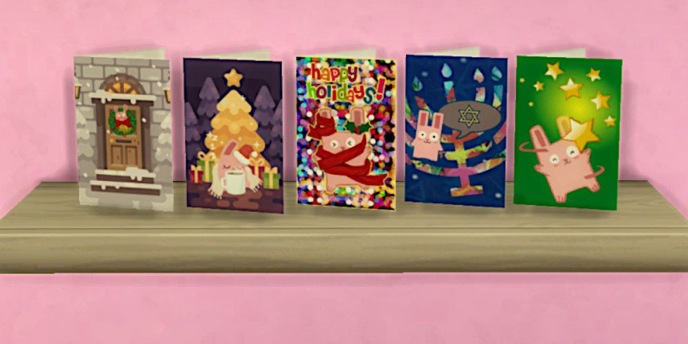 Screenshot of five holiday-themed cards sitting on a shelf in The Sims 4, all featuring the Freezer Bunny mascot character