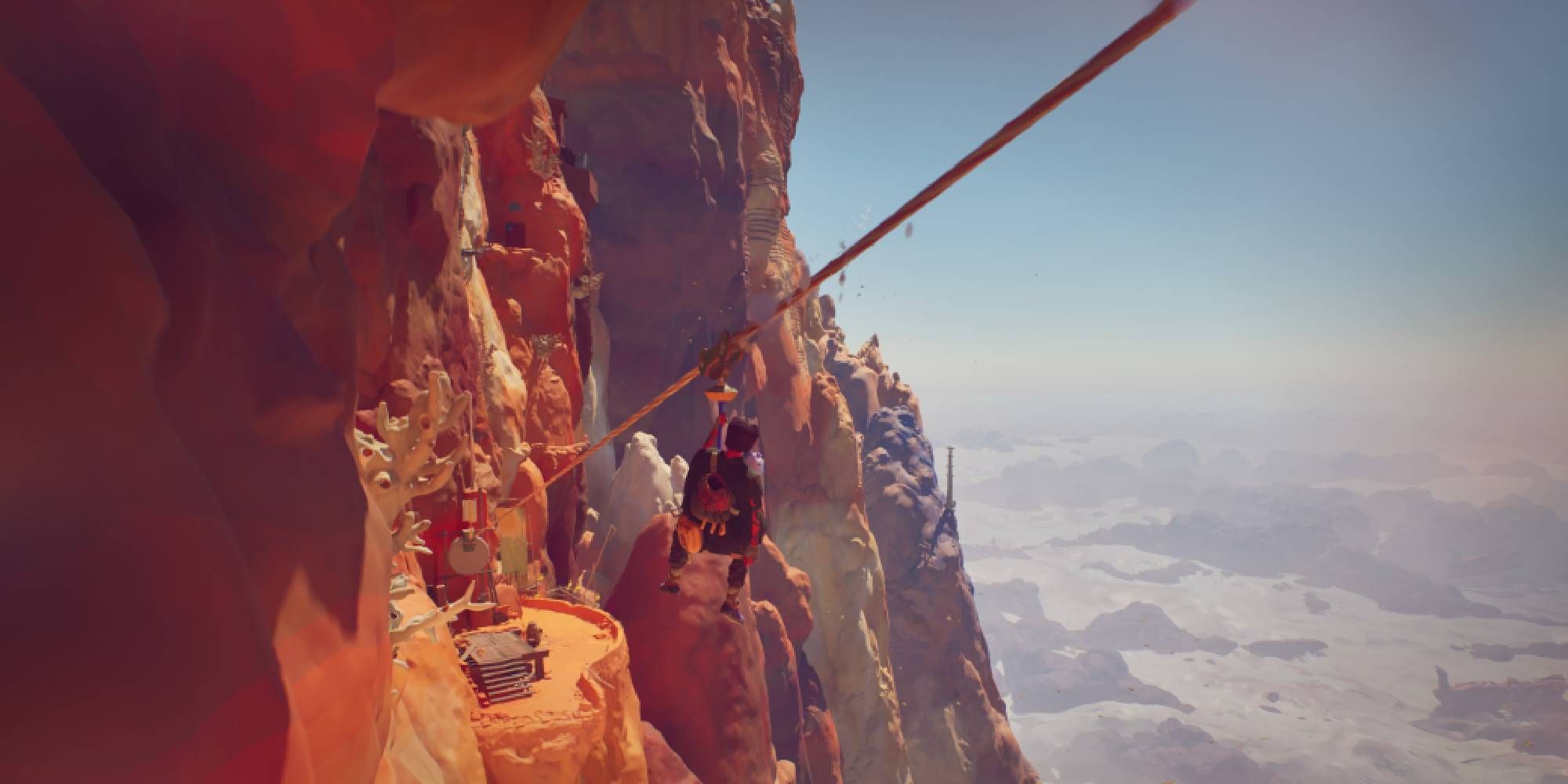 jusant main character riding zip wire alongside cliffside village