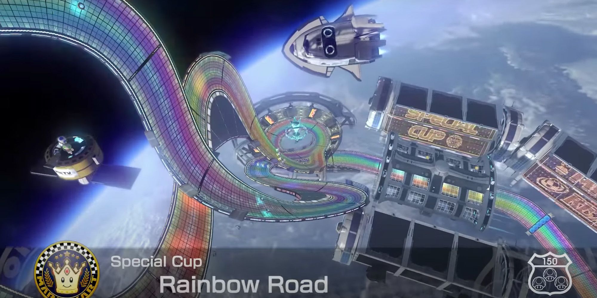 Mario Kart 8 Deluxe - A spaceship and satellite float above Rainbow Road