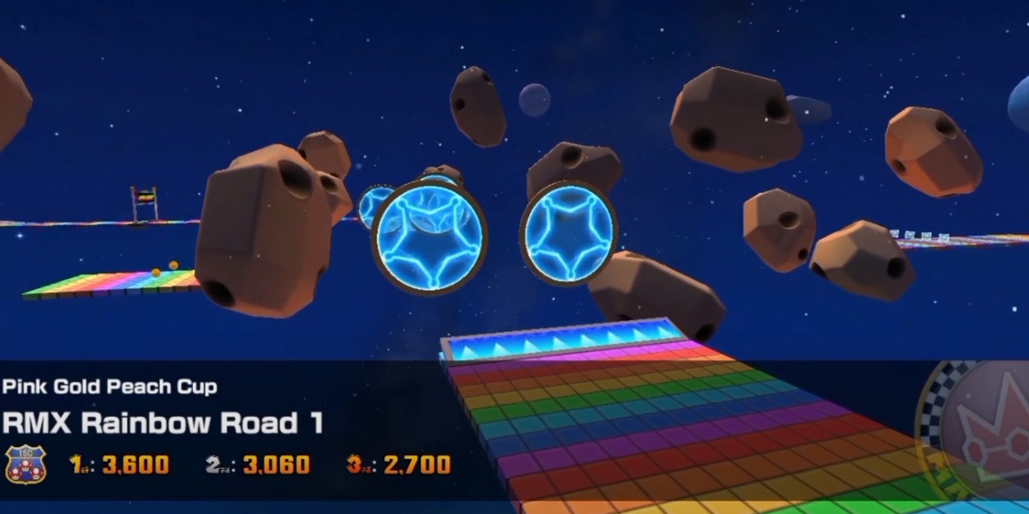 Mario Kart Tour - Asteroids and stars float about RMX Rainbow Road 1