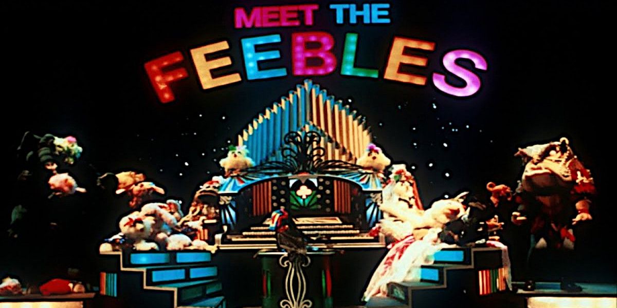 Several muppet-like characters stand on a stage in a low-res scene, with "MEET THE FEEBLES" visible in neon lighting above