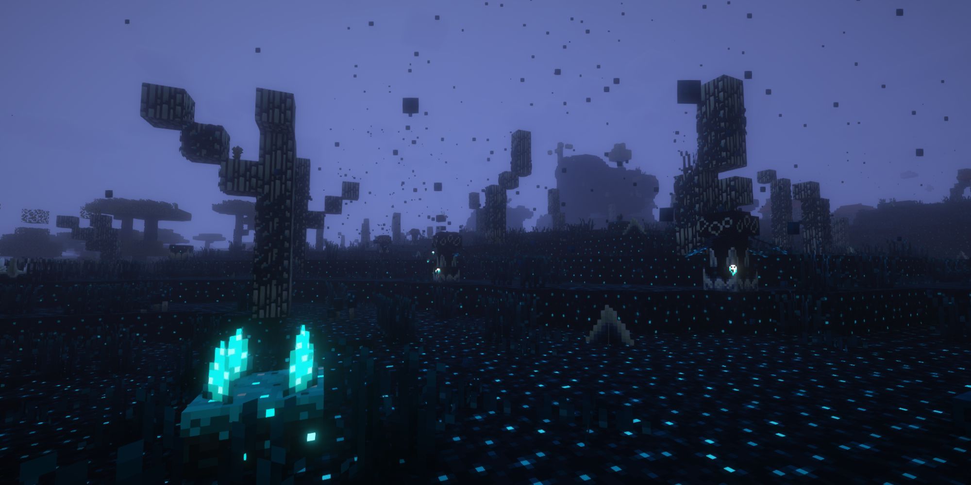 A dark, foggy biome with dead trees and glowing, bright blue flora.