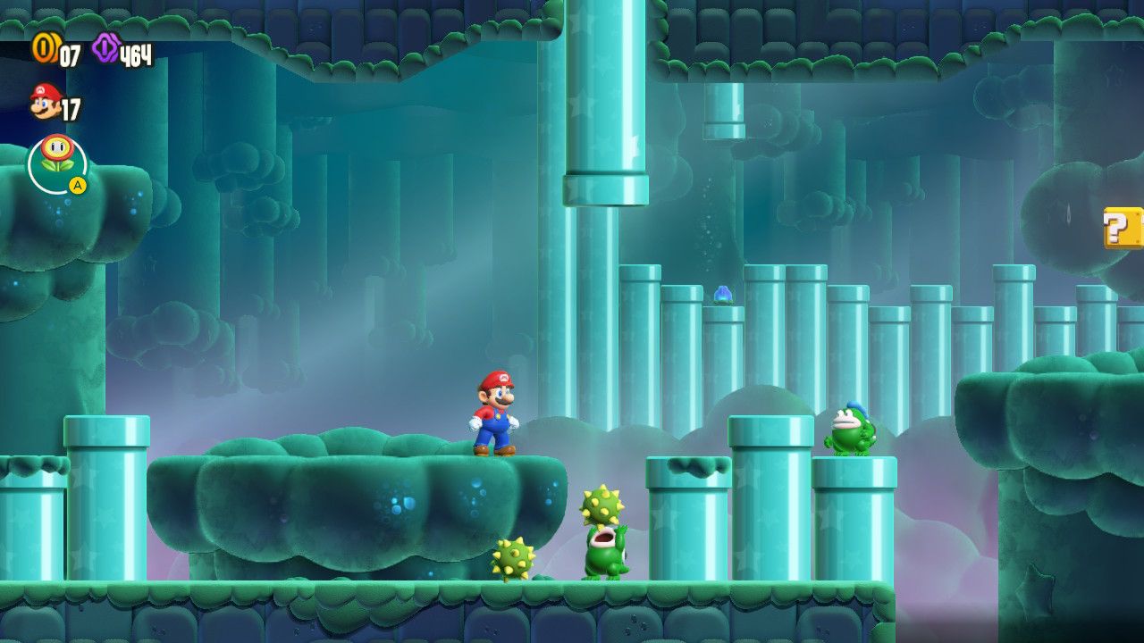 Mario on a platform near 3 pipes. Extra pipes are in the background and a mystery box to the right.