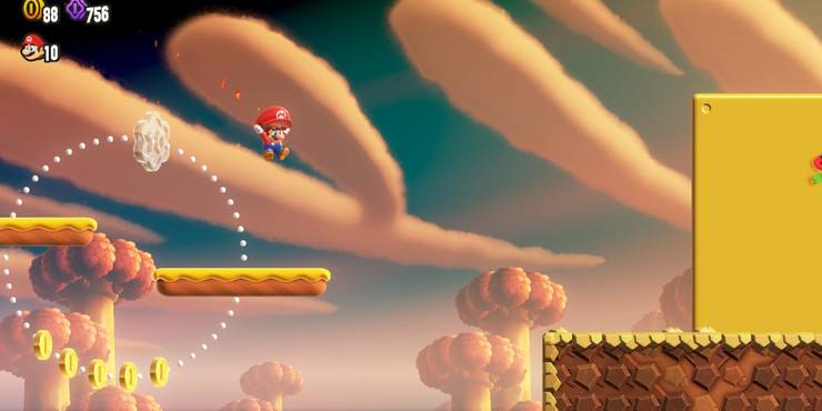 Mario gliding between platforms using the Parachute Cap. 