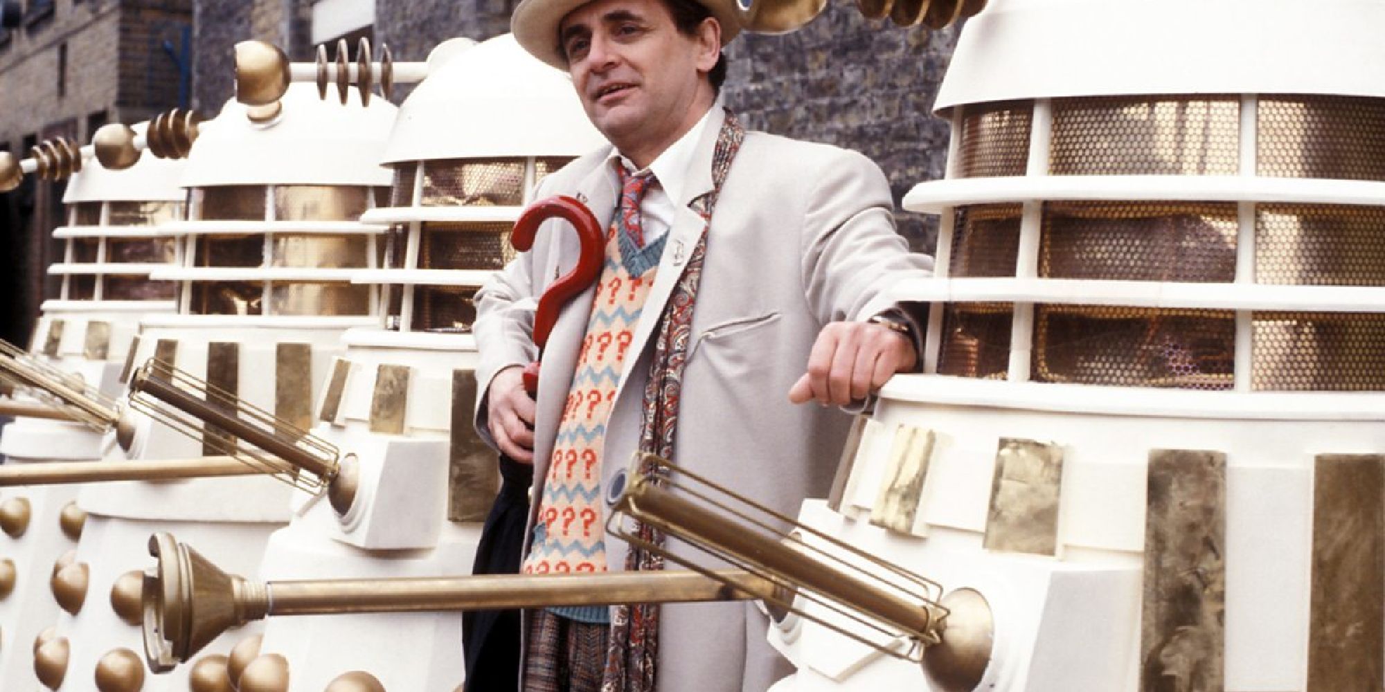 The 7th Doctor standing in a line of white-and-gold daleks in Doctor Who's Remembrance of the Daleks
