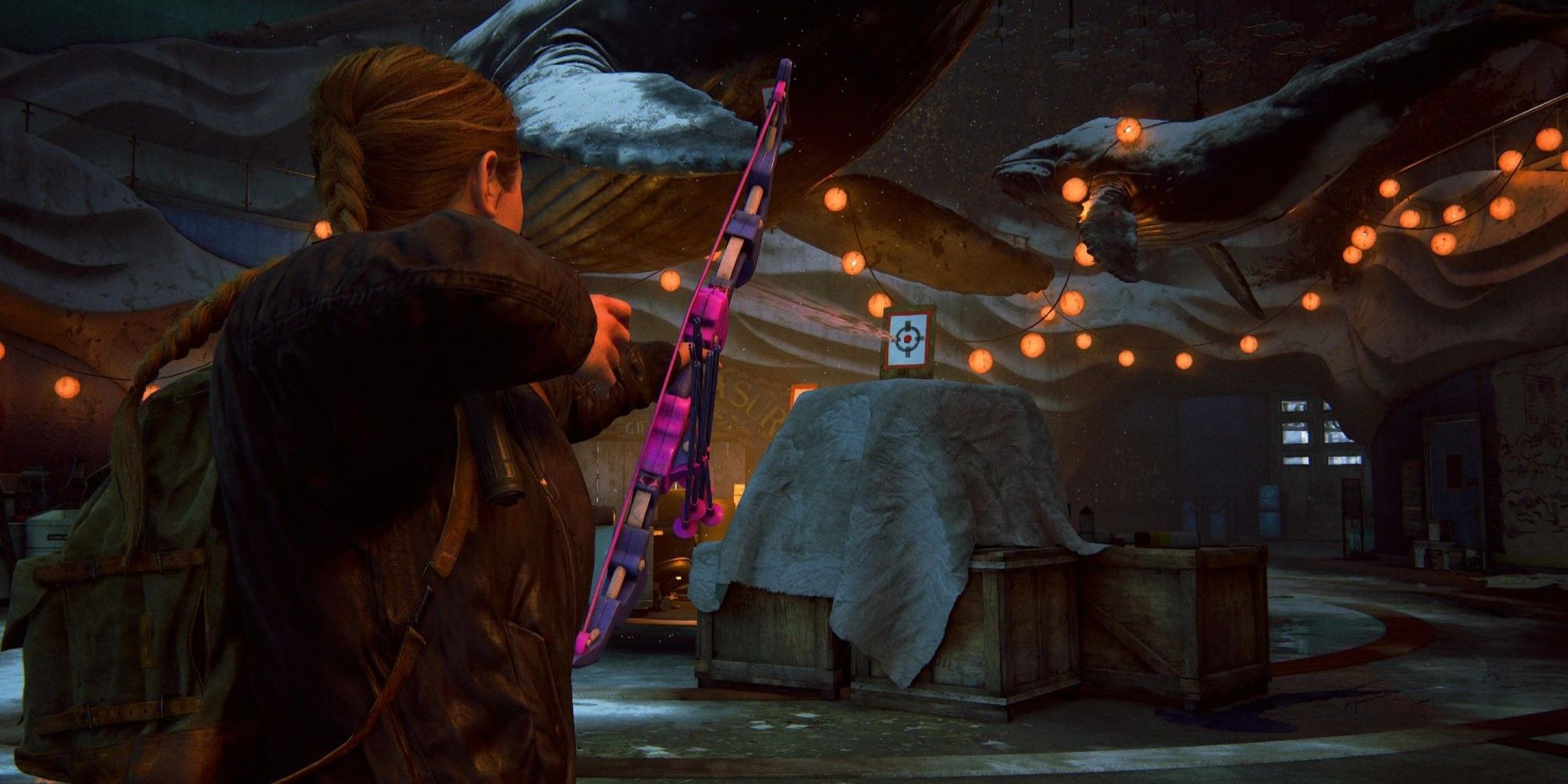 Abby aiming toy arrow in aquarium in The Last of Us Part 2