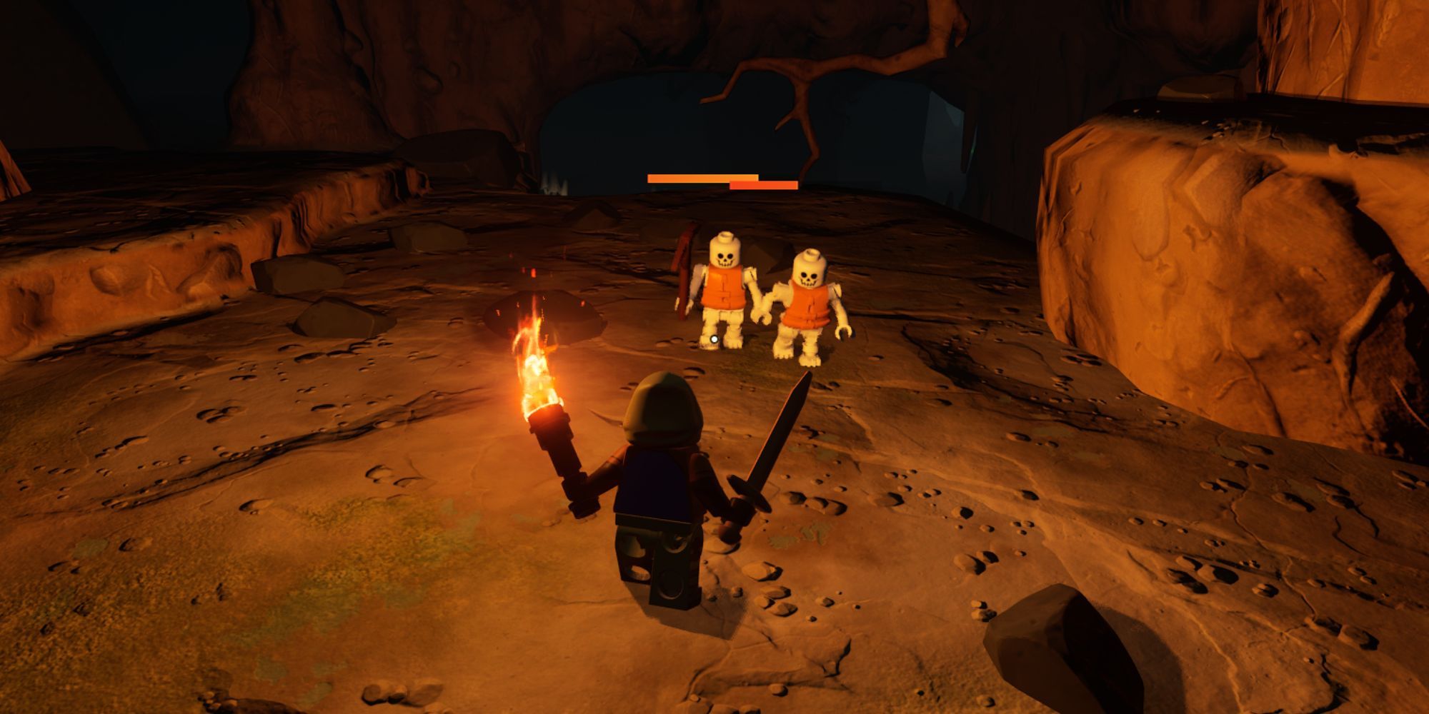 A pair of white skeletons wearing orange vests illuminated by a players torch.