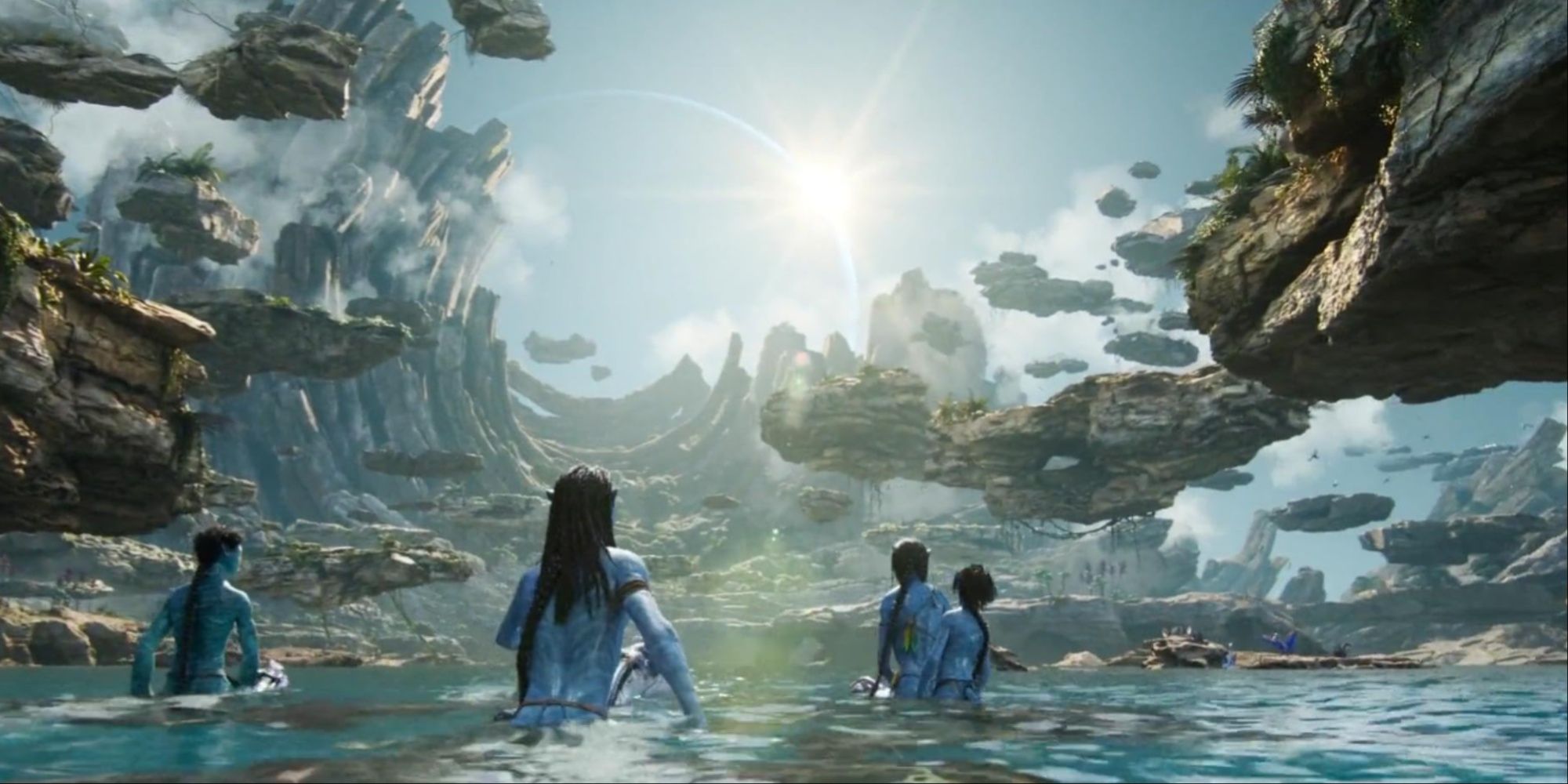 Lo'ak and Kiri emerging from the water into the Metkayina's Cove of Ancestors, floating rocks all around.