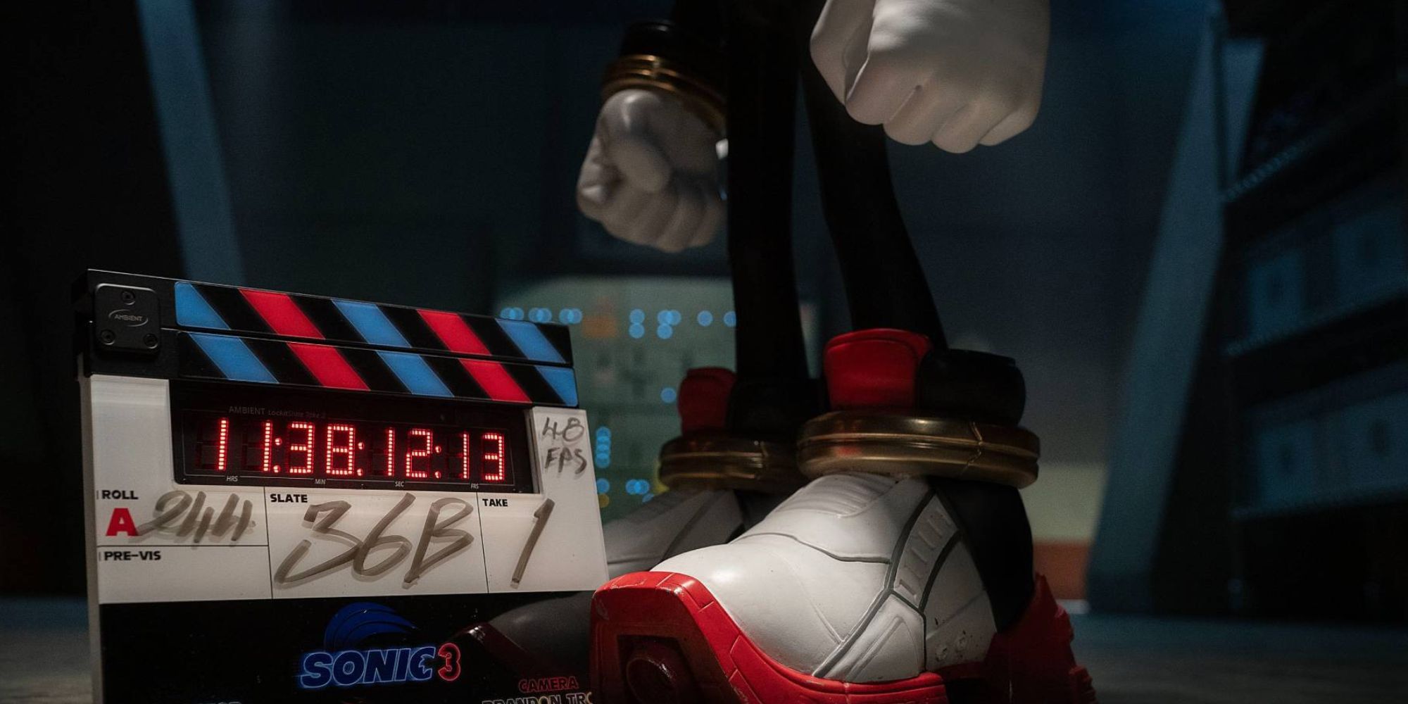 Shadow the Hedgehog's foot and leg in a promotional still for the Sonic 3 movie. He's stood next to a clapperboard