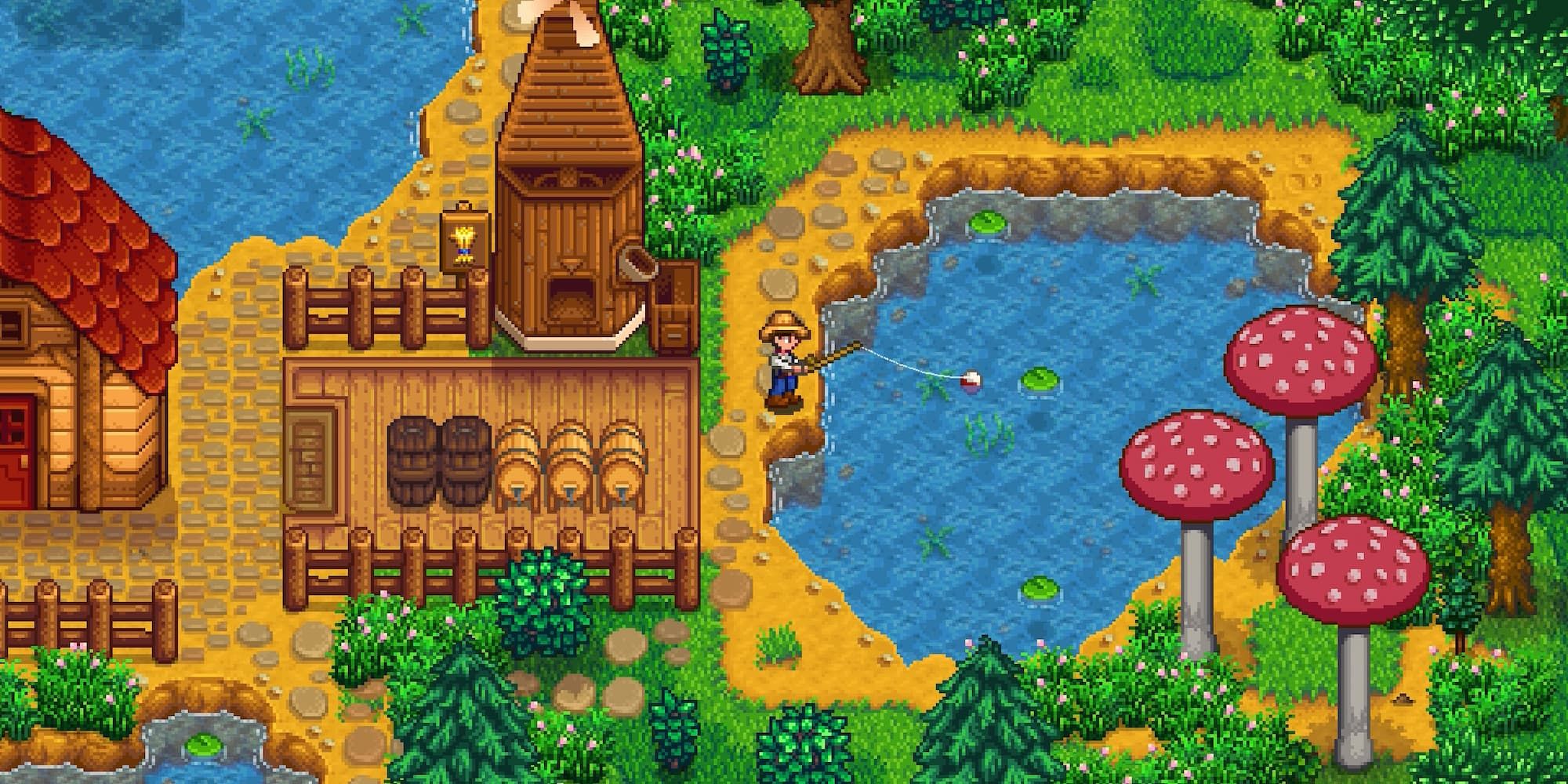A man fishes in a pond next to a windmill in Stardew Valley.