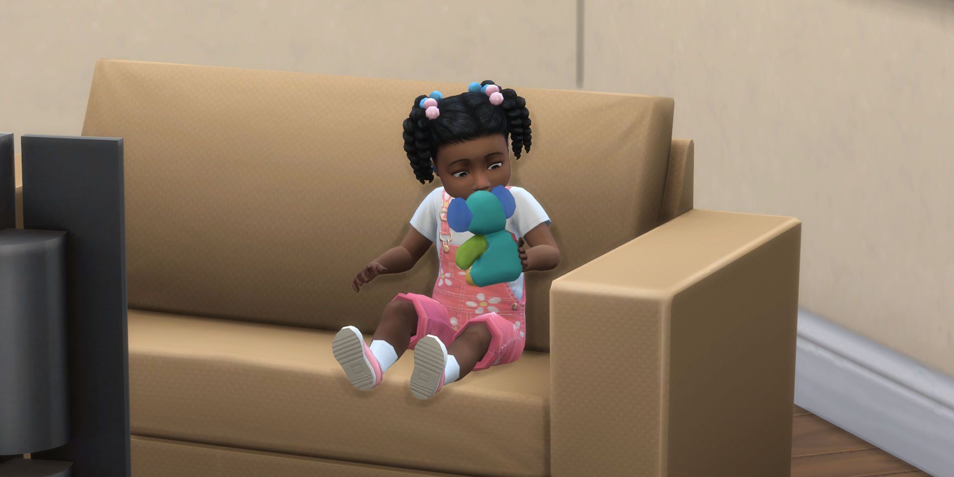 A toddler playing with a Koala toy in The Sims 4.