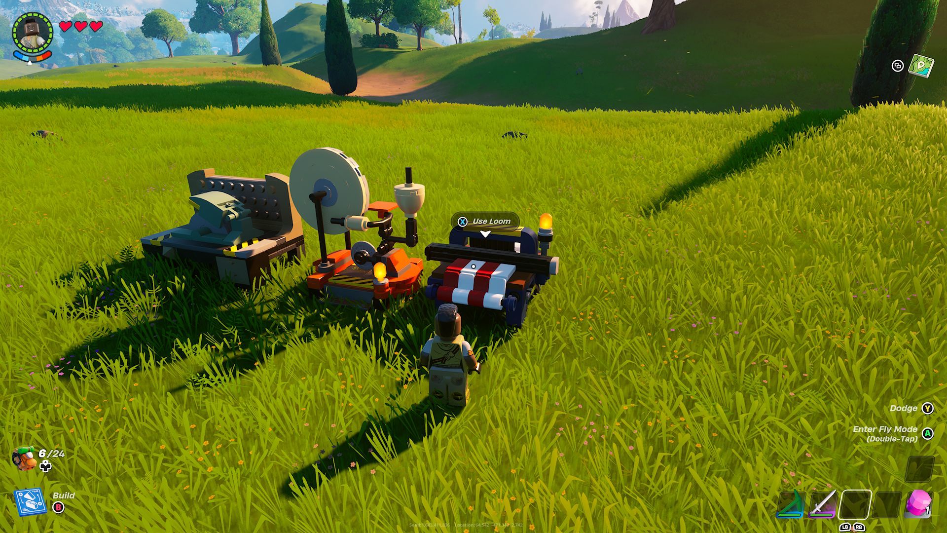 A player approaching a loom, next to a spinning wheel and crafting bench in the middle of a field in Lego Fortnite.