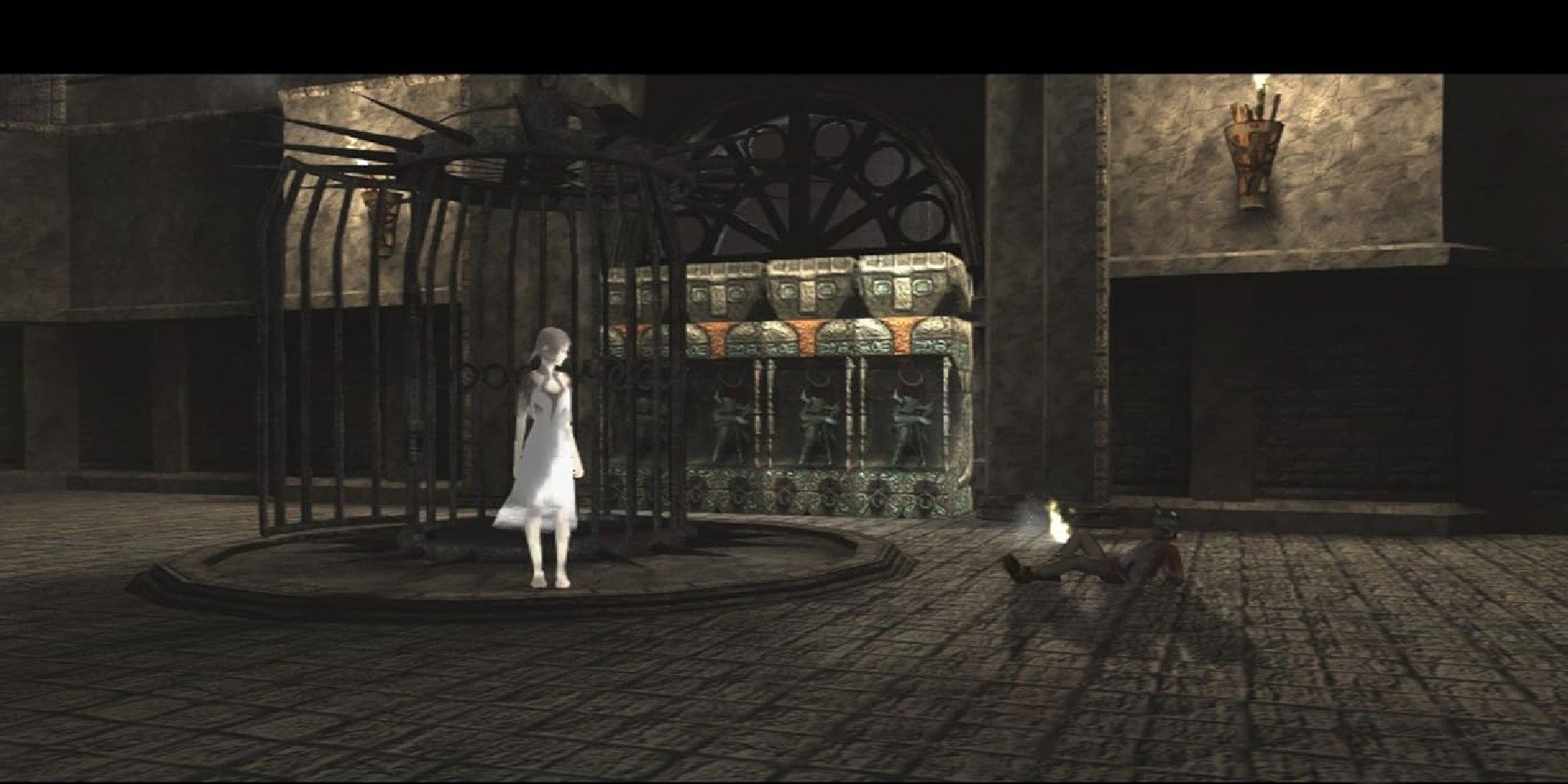 Ico und Yorda treffen sich neben einem Käfig.