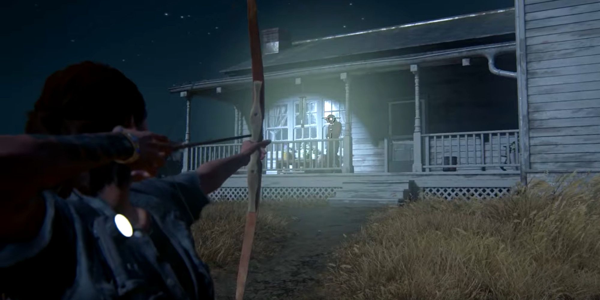 Ellie aiming her bow at a clicker that is stood on the porch of her farm house