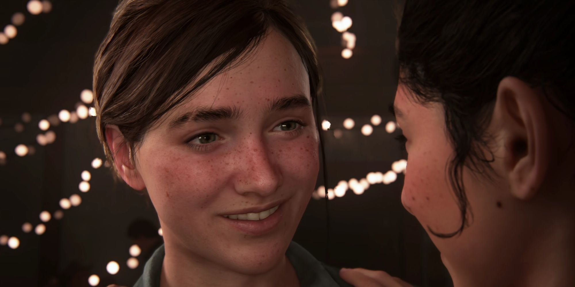 Ellie smiling at Dina in The Last of Us Part 2.