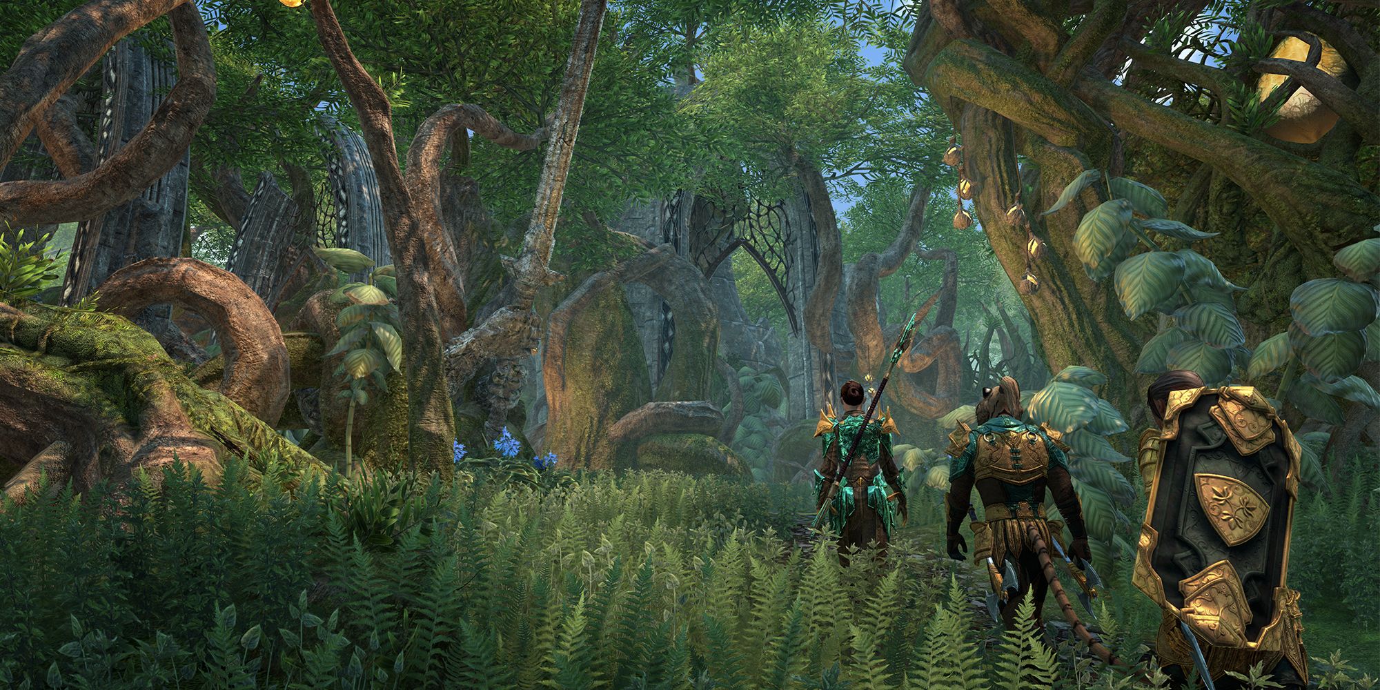 ESO Gold Road screenshot of adventurers entering an ayleid ruin covered in jungle trees