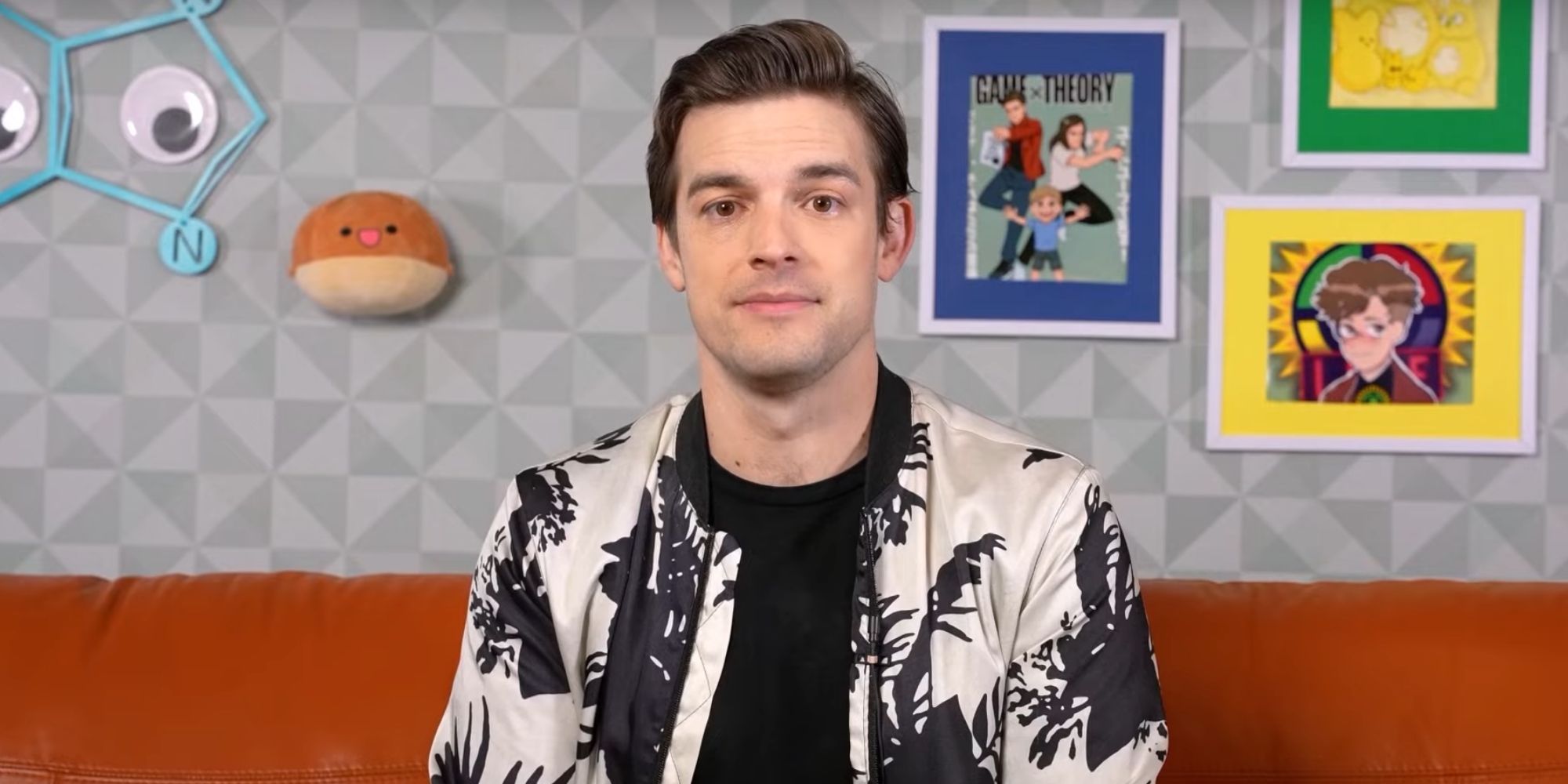 MatPat sitting on a couch wearing a black and white shirt-1