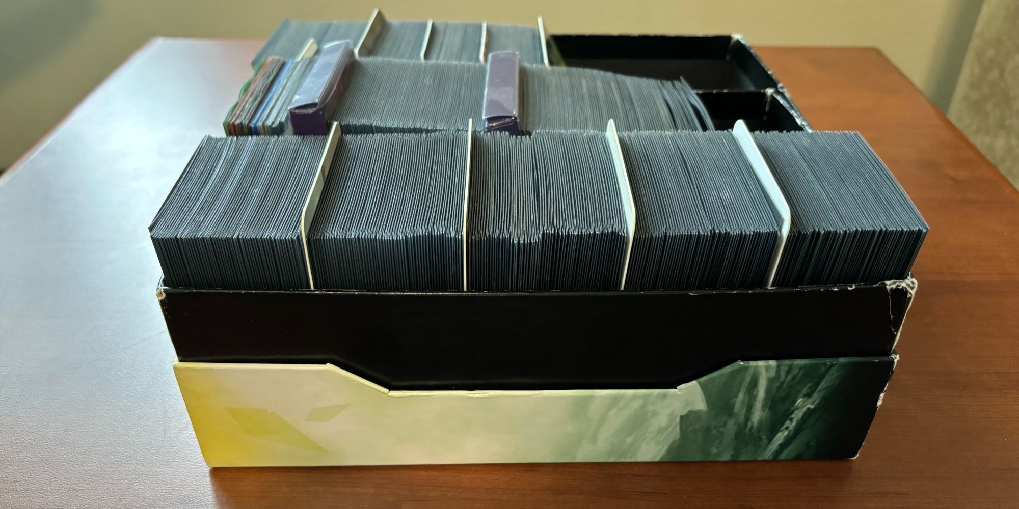 A storage box containing 450 double-sleeved Magic cards, including basic lands and tokens.