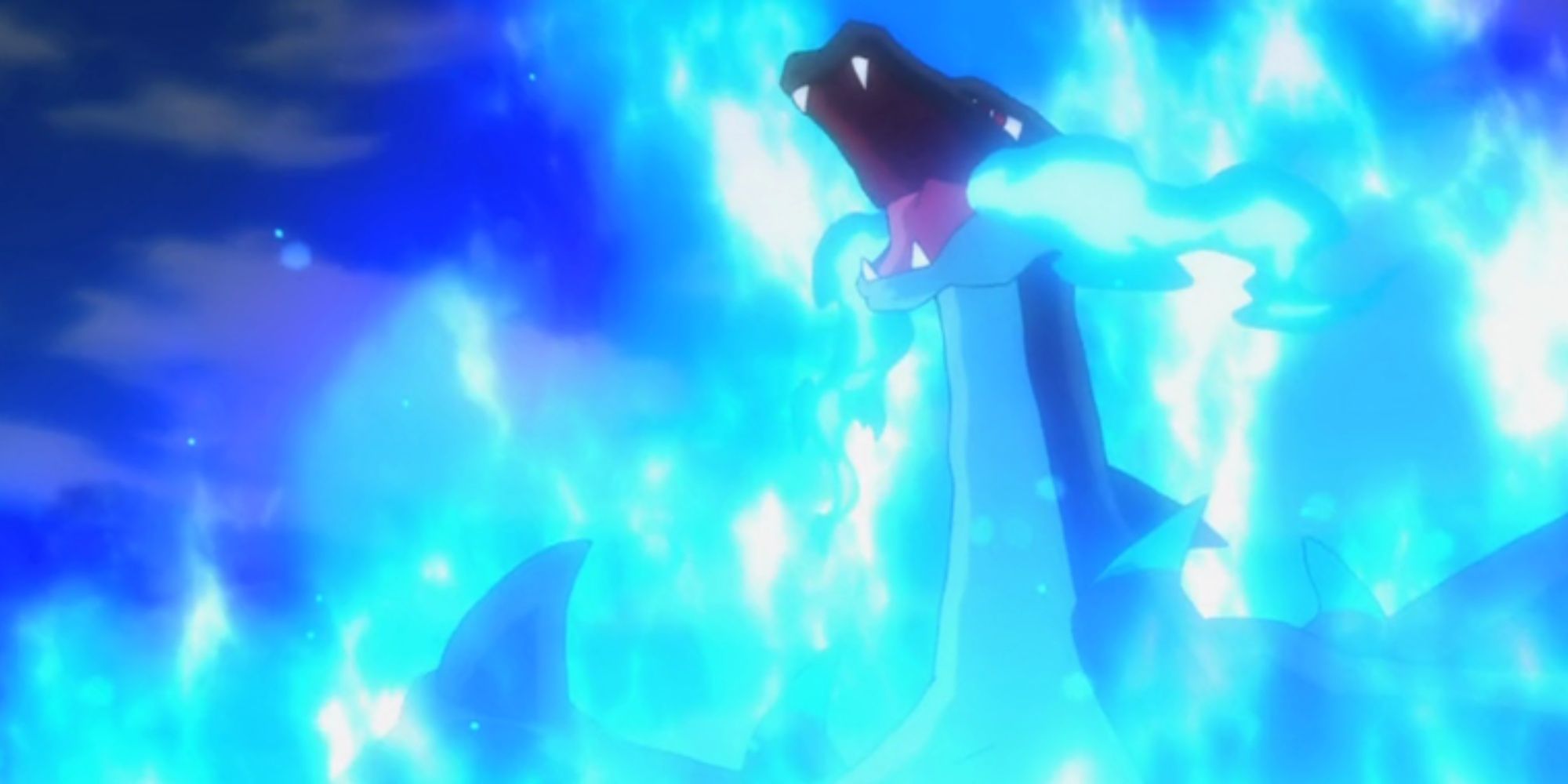 Mega Charizard X in the anime unleashes a Blast Burn attack, surrounded by blue flames.