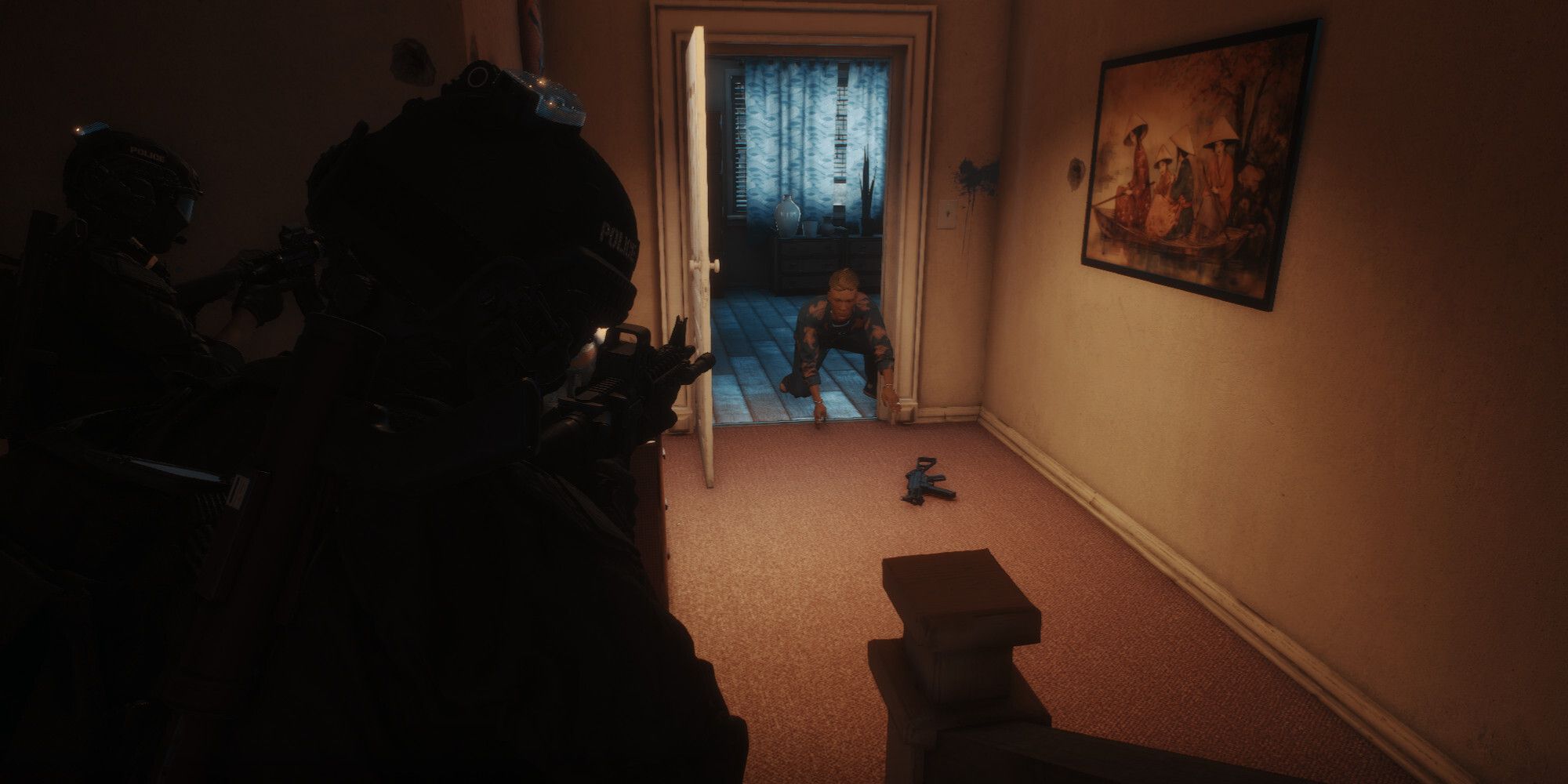 Operators take aim at a suspect trying to grab gun off the floor