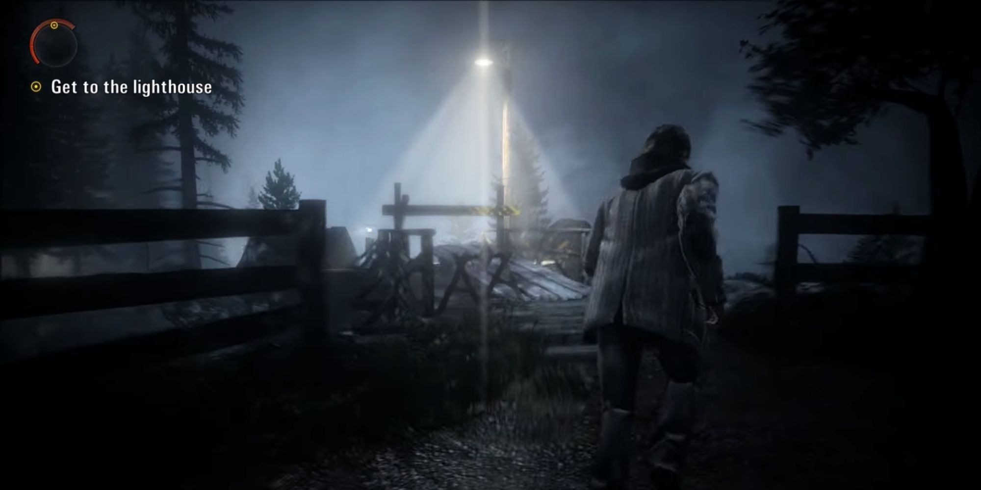 Alan Wake approaches a lone streetlamp by a bridge in the dark