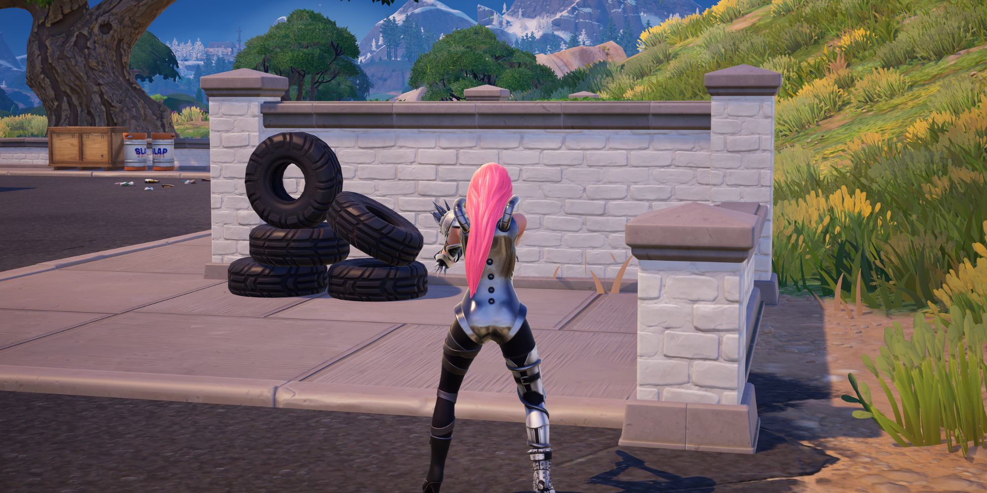 An image from Fortnite of the playable character looking at a pile of tires at a gas station.