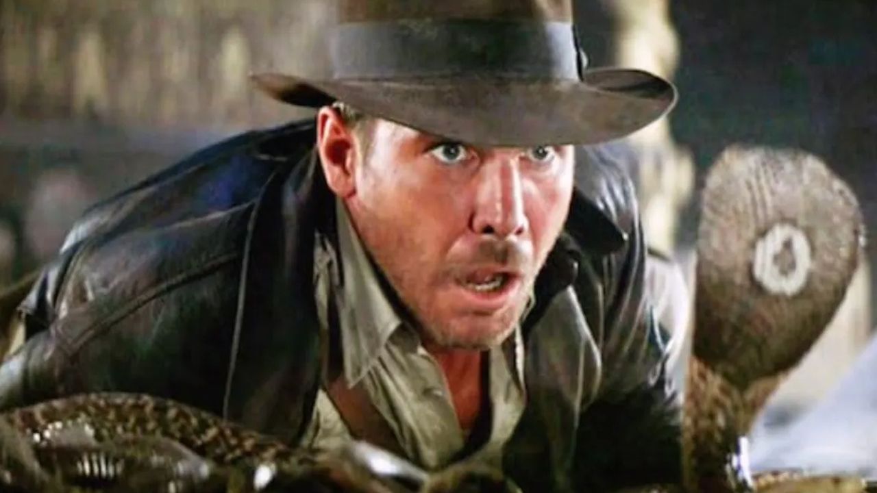 Indiana Jones encounters a cobra and stares in fear.