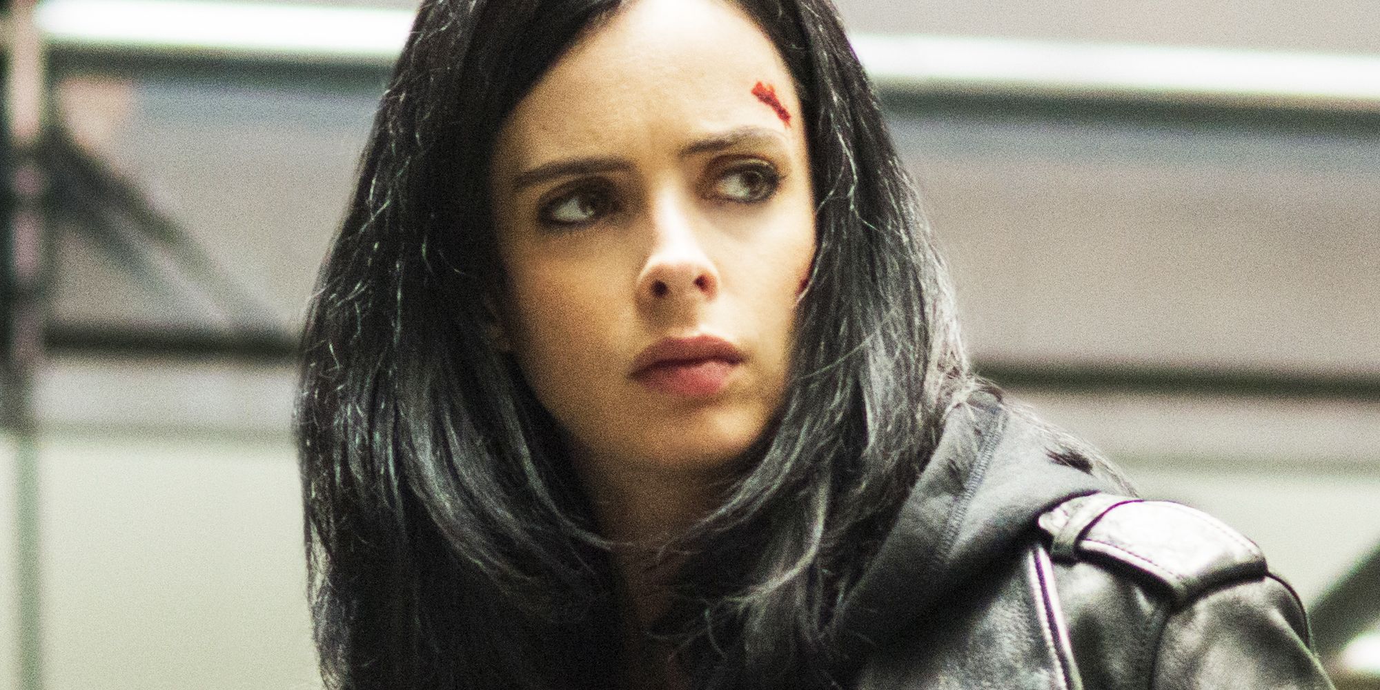 Krysten Ritter in Jessica Jones lookking up with blood on her forehead