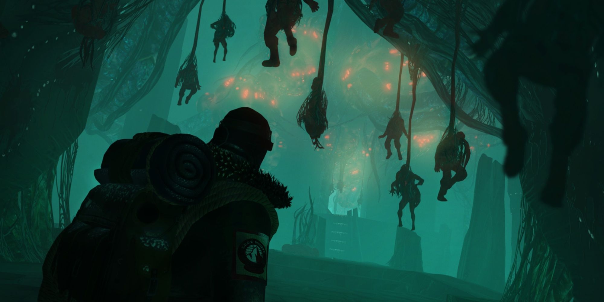 The protagonist Antarctic explorer walking into a chamber with bodies hanging from cocoons and an alien Lovecraftian creature with red orbs seen in the background.