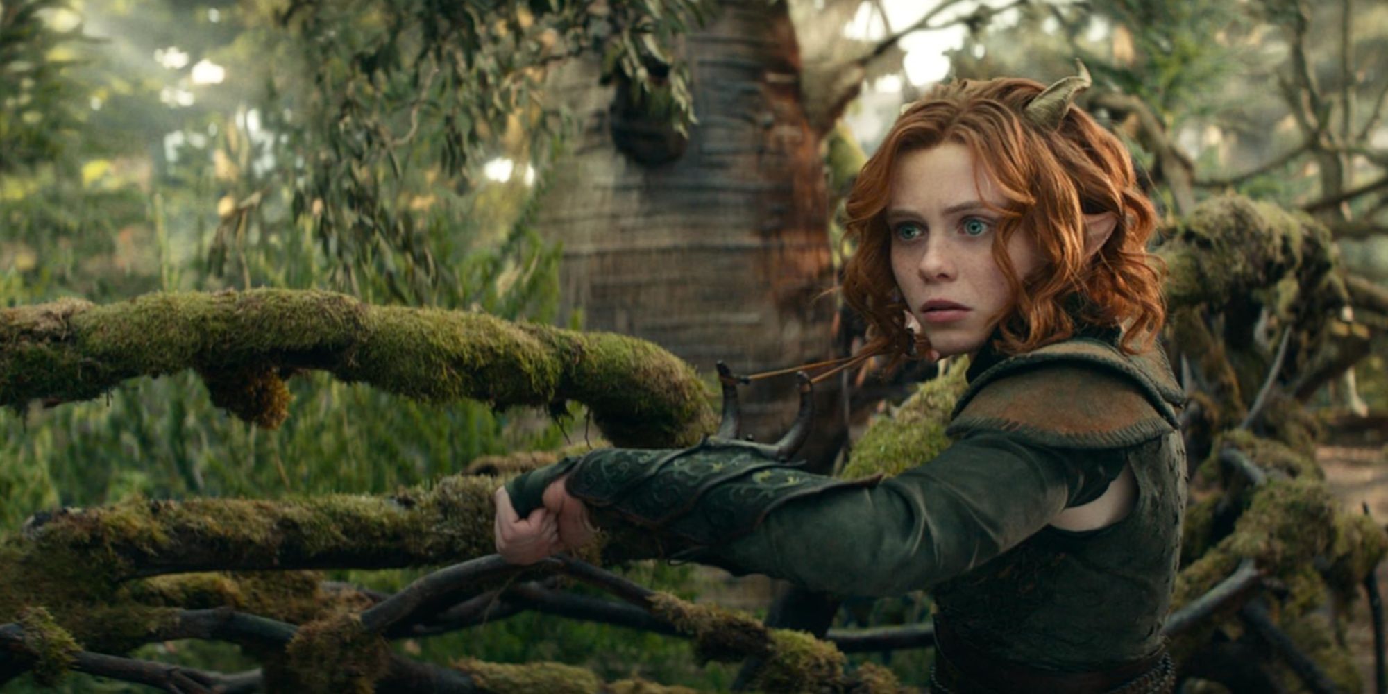 Sophia Lillis as her Tiefling character Doric in a mossy forest in the 2023 D&D: Honor Among Thieves film.