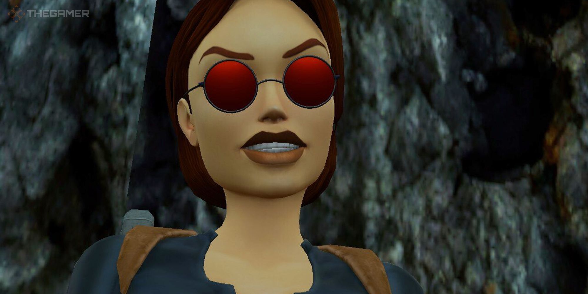 Tomb Raider Remastered Lara Croft smiling in a cave in her catsuit with red circular sunglasses on