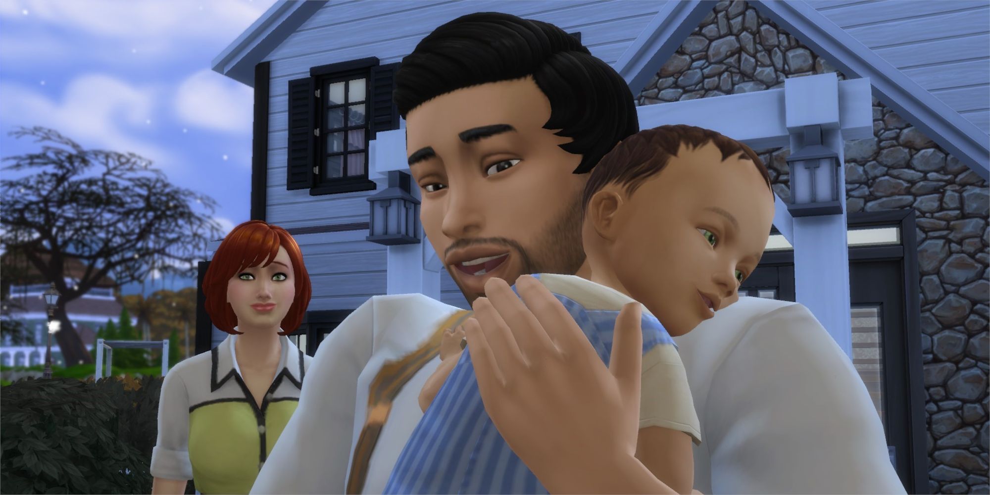 Adult male sim poses with an infant male with an adult female in the background.