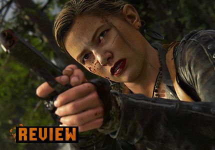 The Last of Us Part 2 Review with Abby holding a pistol