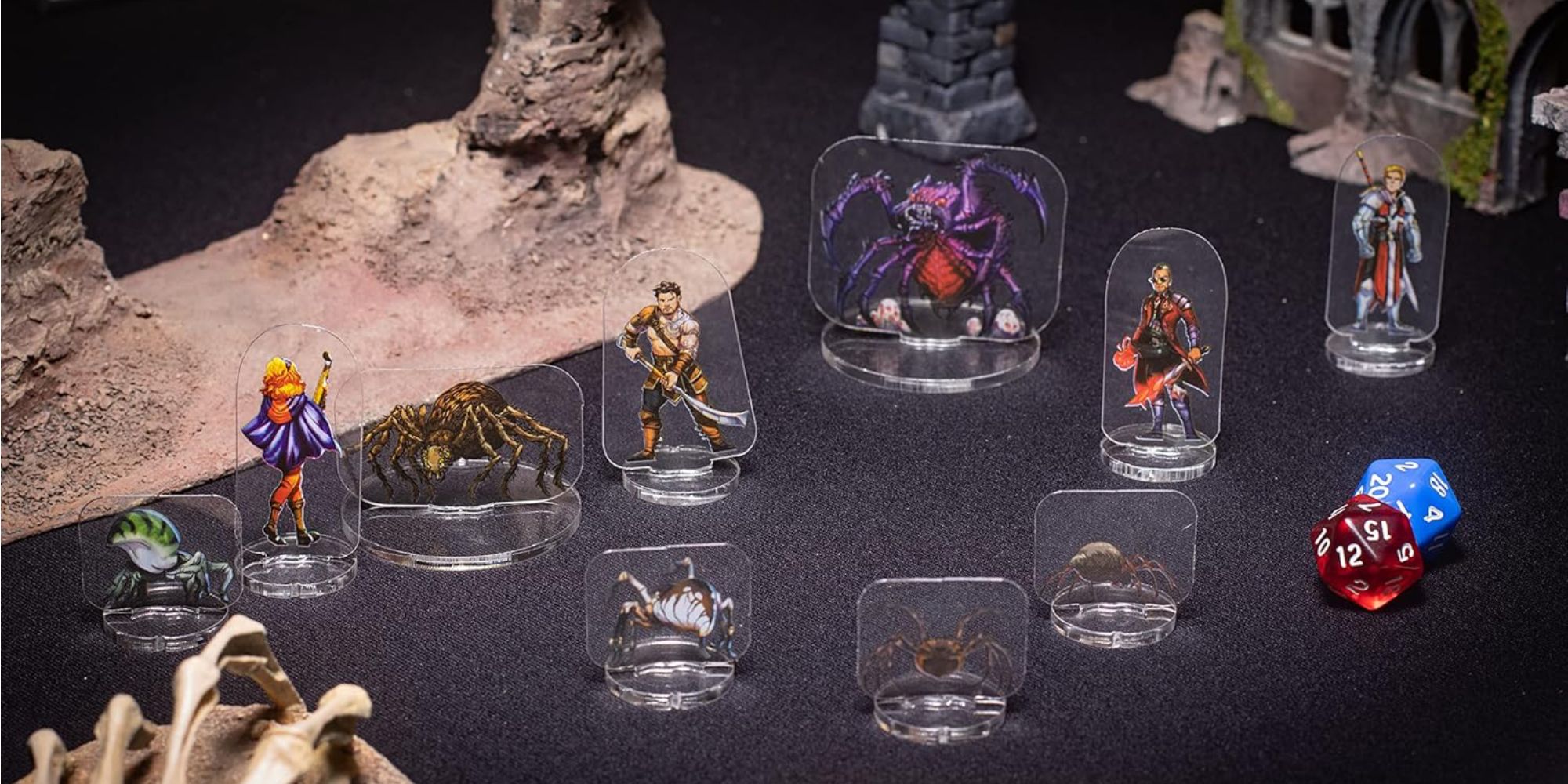 A photo of ArcKnight miniatures on a gaming table, including adventurers and arachnid monsters.