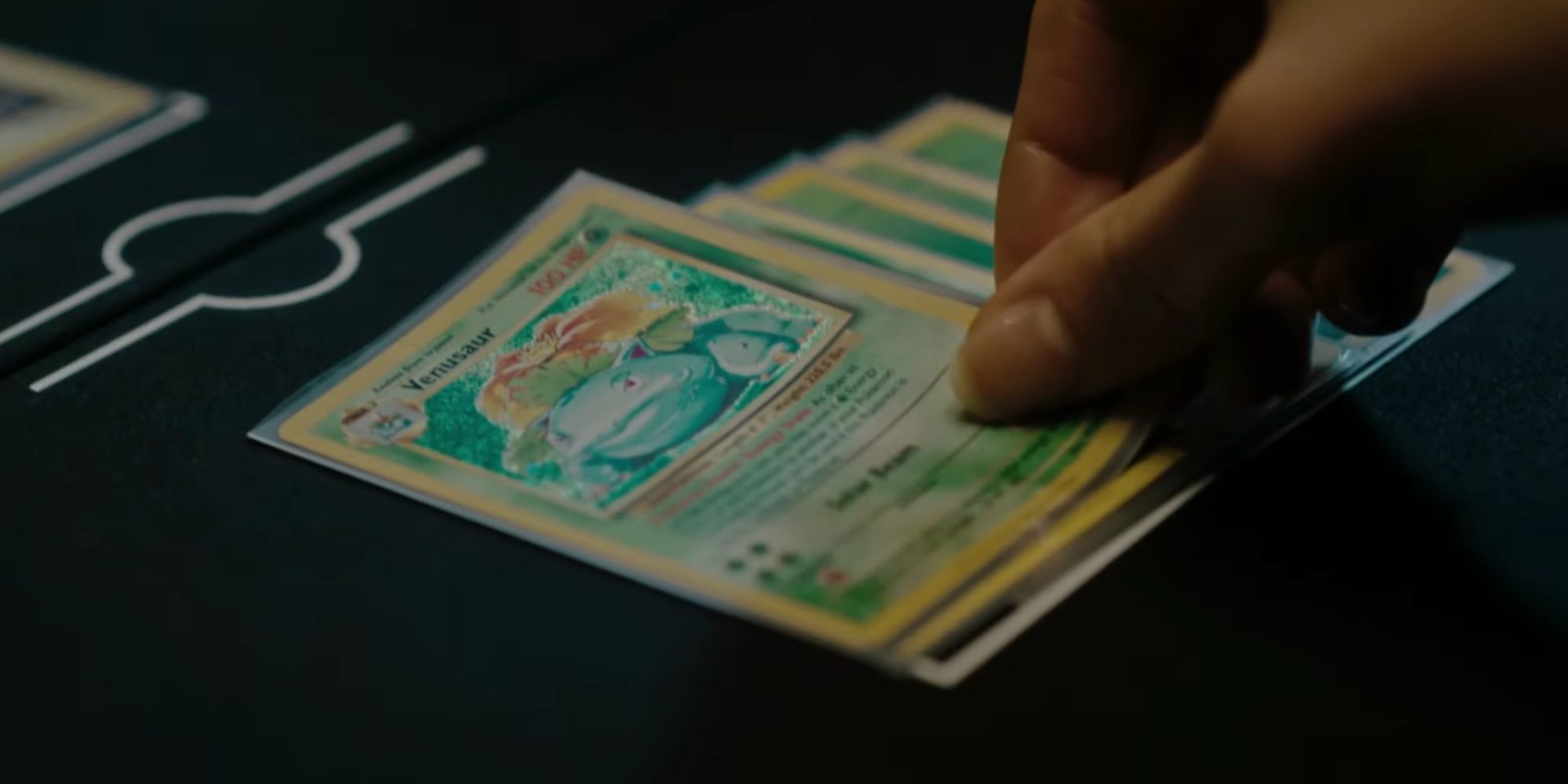 someone putting down a venasaur card in the pokemon tcg classic