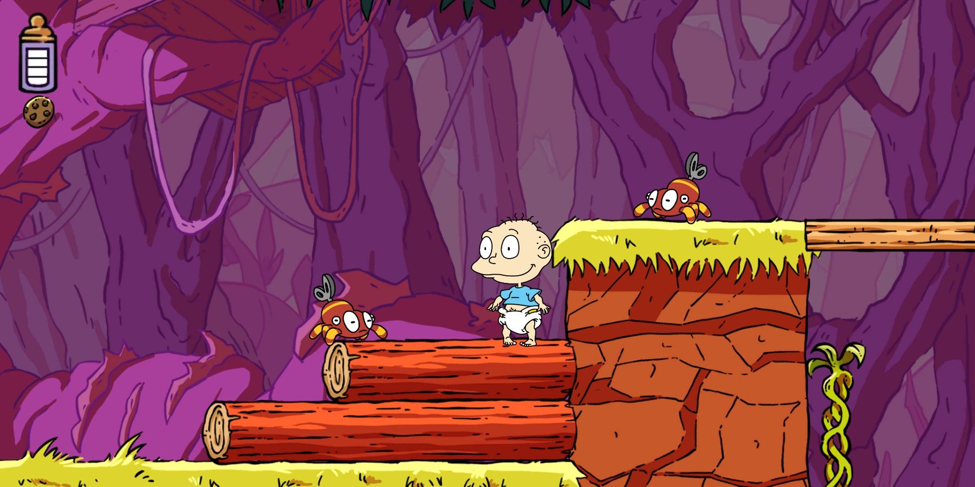 Rugrats Adventures in Gameland with Tommy in a jungle setting with fallen logs and vines