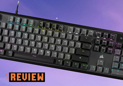 Corsair K70 keyboard over a purple background with the word 'review' in the bottom left