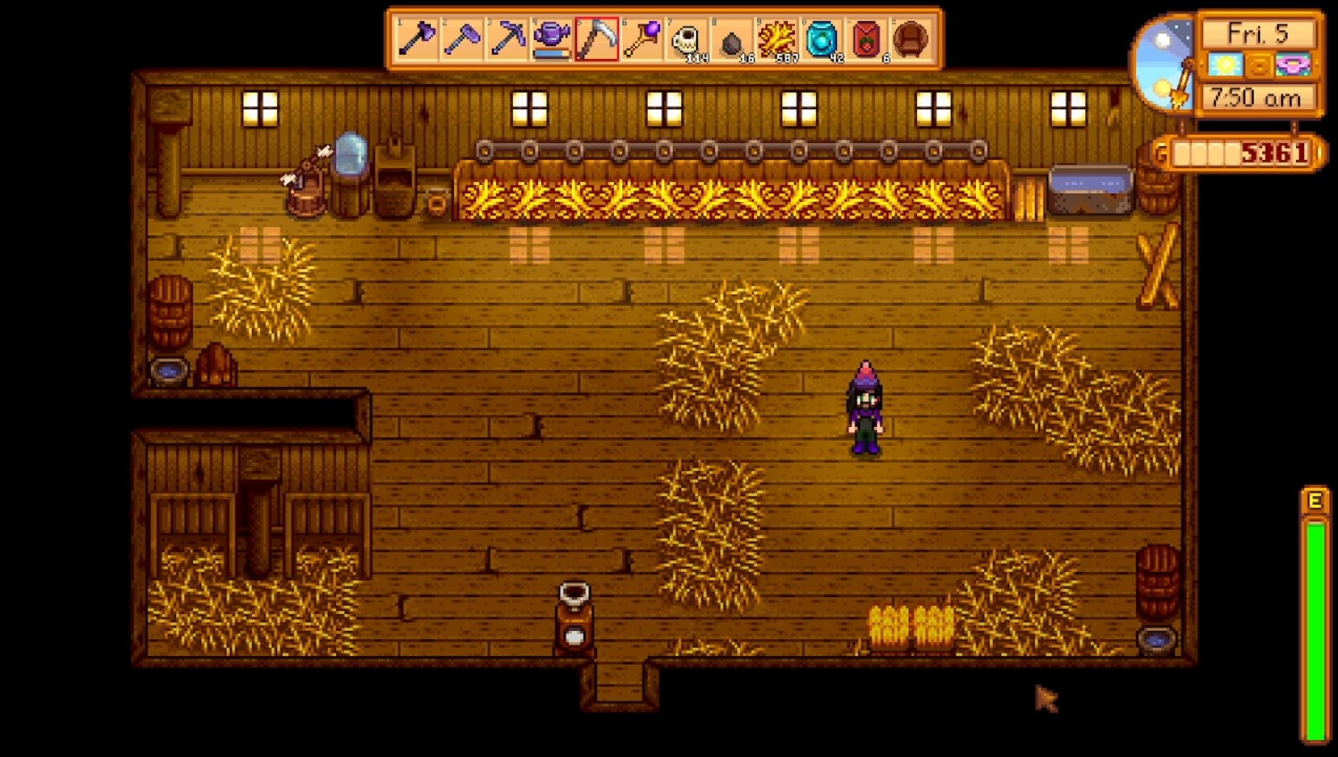 a farmer in a barn with filled troughs stardew valley