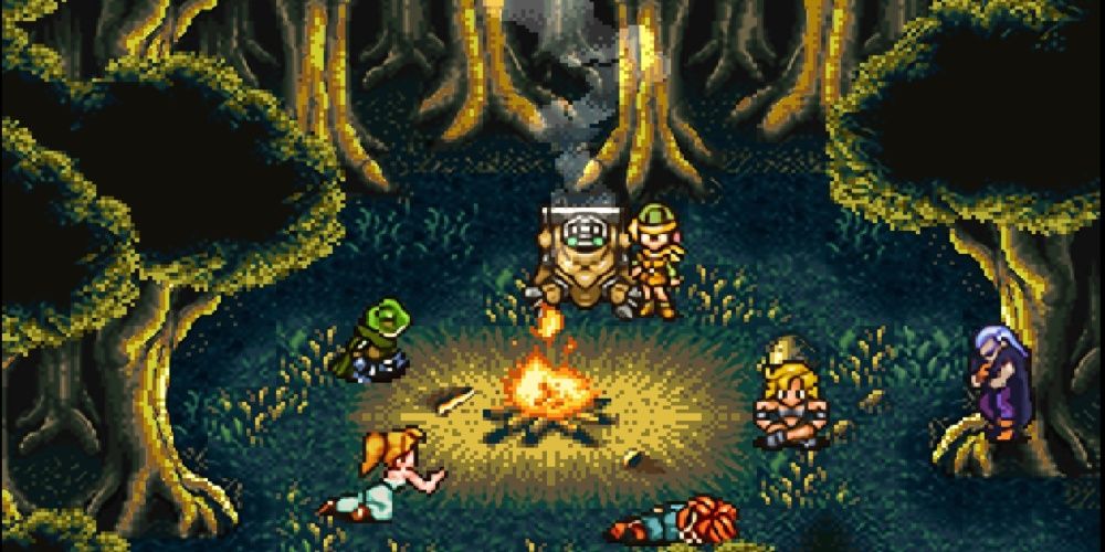 Crono's group rests around a campfire in a forest in Chrono Trigger.