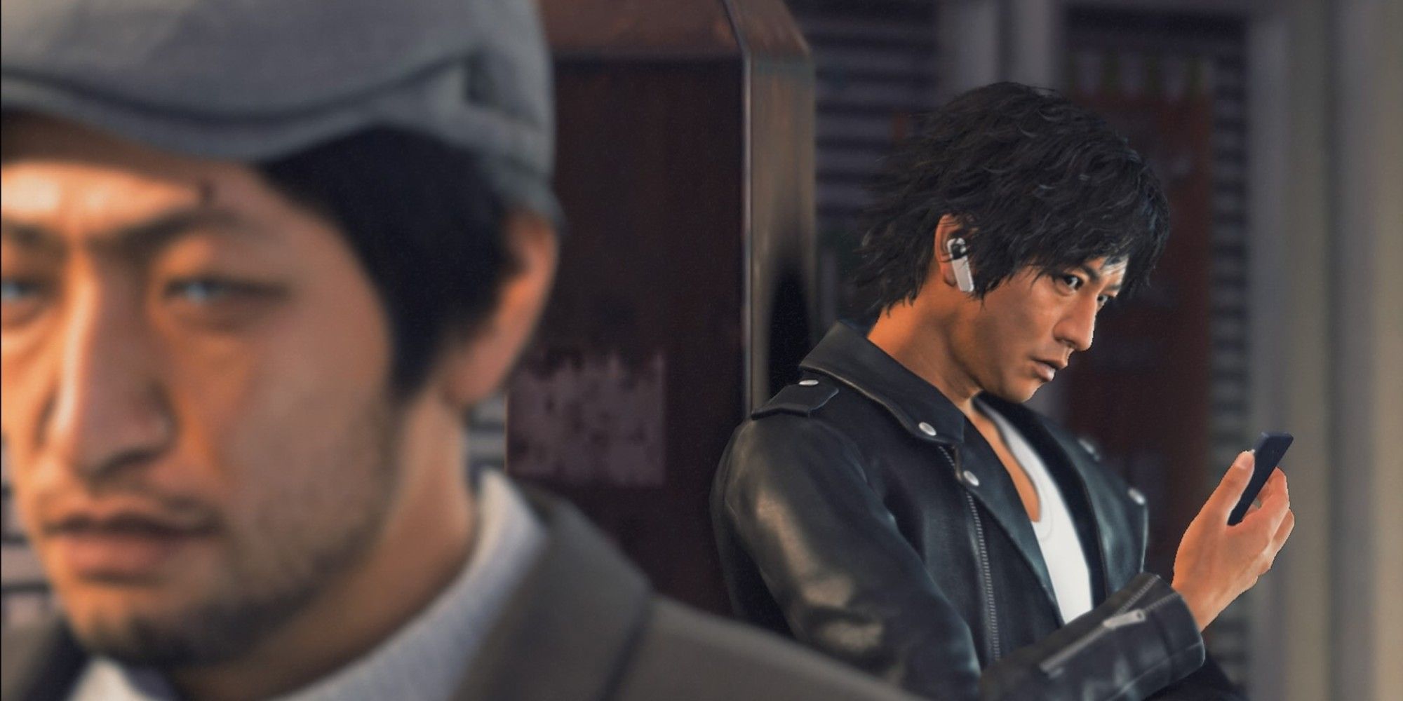 Yagami in Judgment glances up from his phone at a guy he's tailing