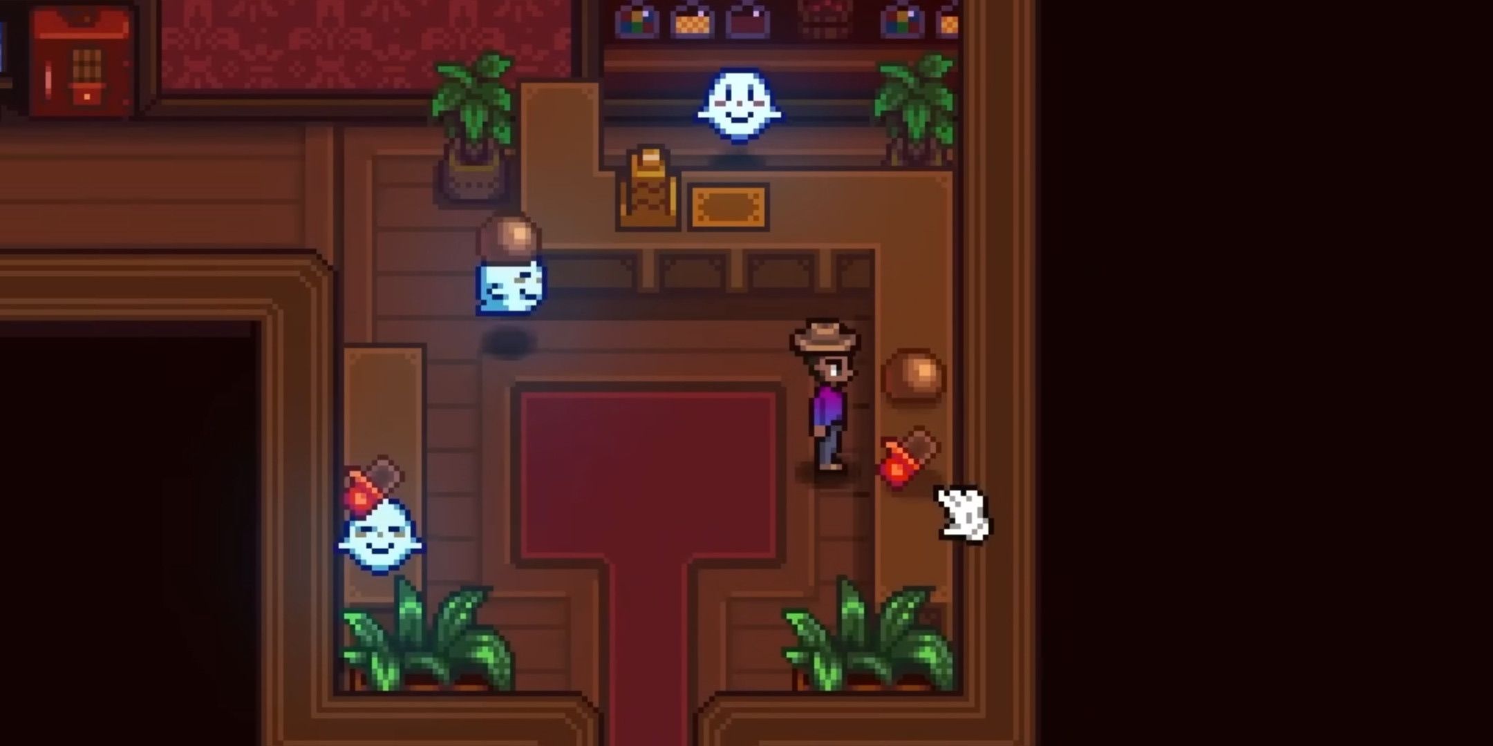 A man in a hotel lobby with three small ghosts