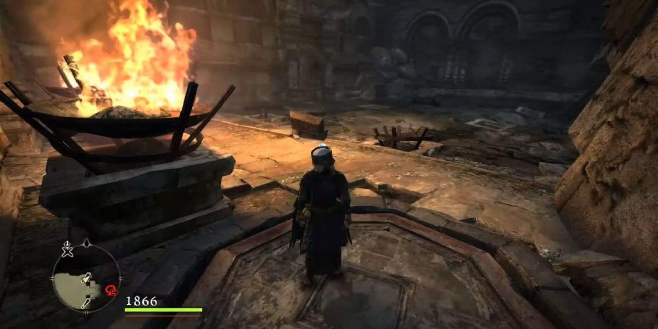 dragon's dogma image showing A mage standing by a flaming sconce