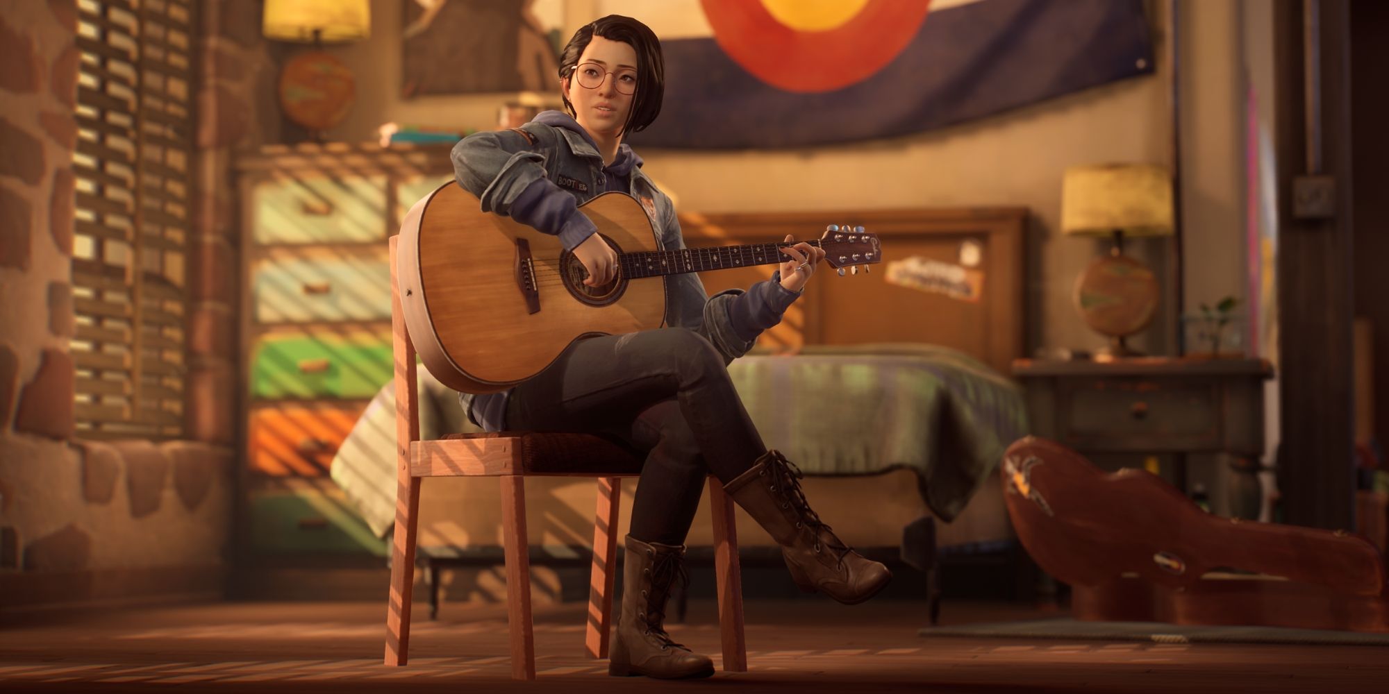 Alex Chen sits on a chair in front of the bed playing the guitar in Life Is Strange: True Colors