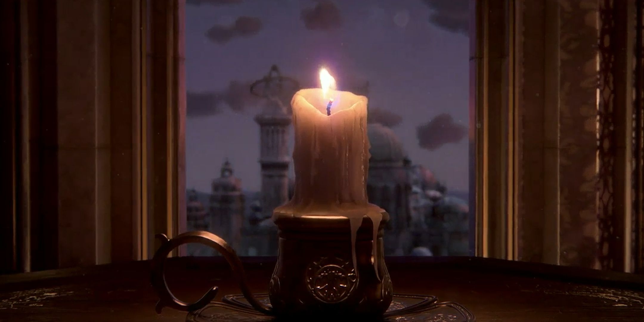 Sand of Time Remake candle on a table in front of a city