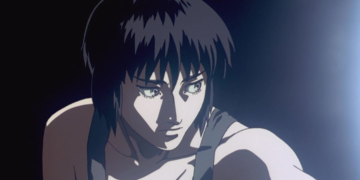 Motoko Kusanagi wakes in a dimly lit room.