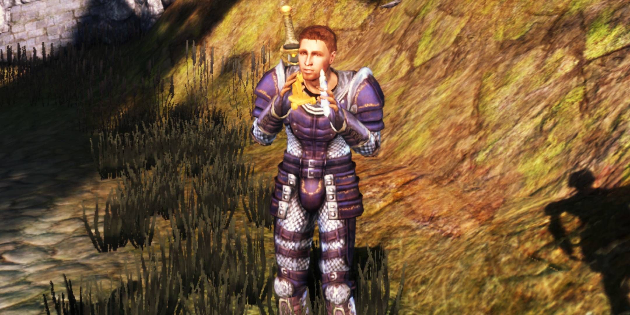 Alistair playing with the Grey Warden Hand Puppet gift in Dragon Age: Origins